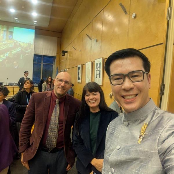 Three people smiling at the camera