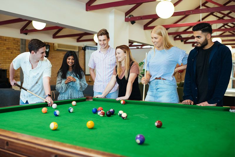 Residents playing pool in International House Green Room