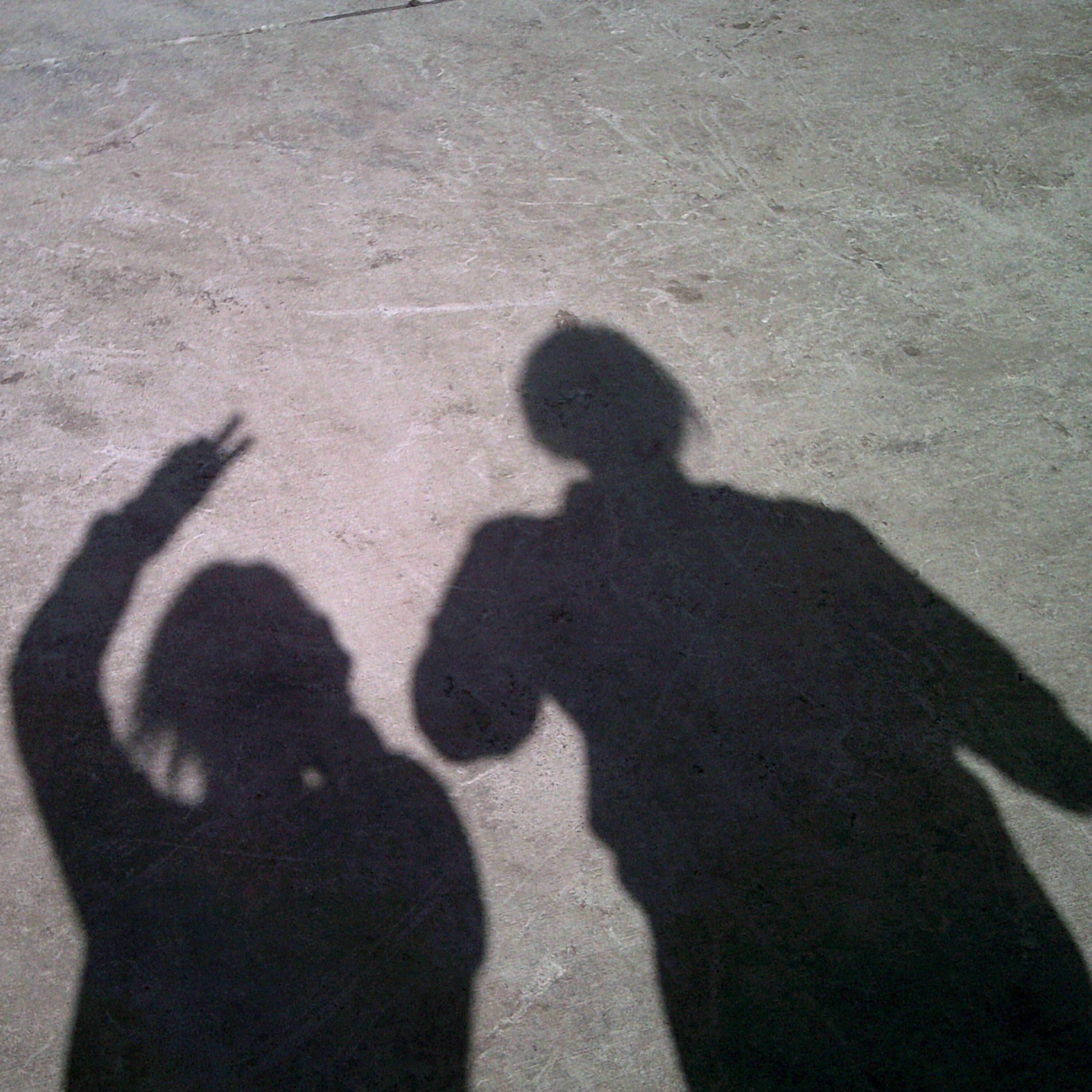 Photo shows the shadows of two people against concrete ground^empty:{ds__assetid^as_asset:asset_name}