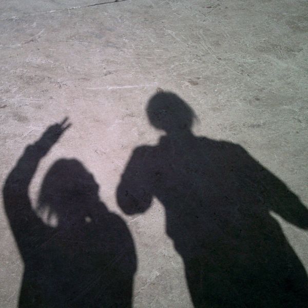 Photo shows the shadows of two people against concrete ground. Program receives funding to continue work to address youth violence