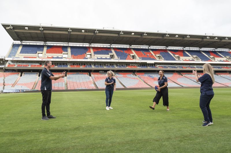 The Mark Hughes Foundation team toss the football around on the field