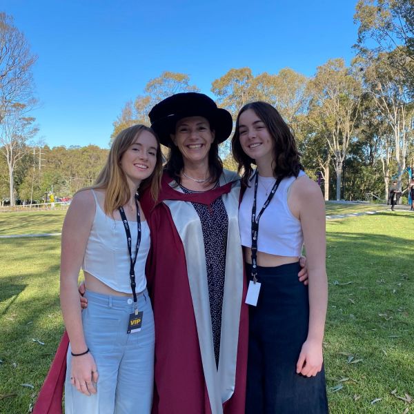 A mother and her two children at graduation. A flying affair: students touchdown for graduation.
