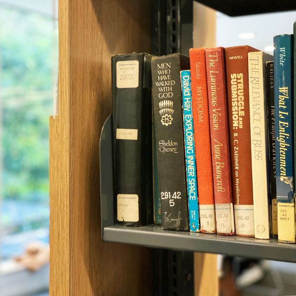 Close up image of book spines, with blurred out background.