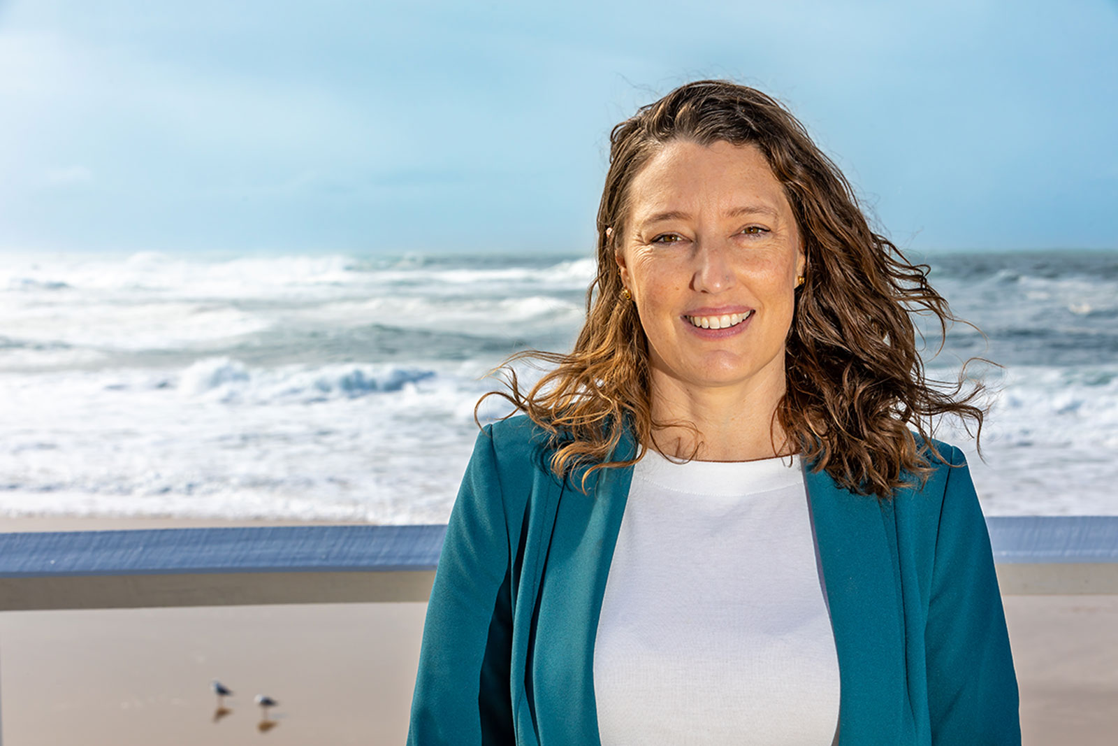 Dr Sascha Fuller standing in front of the ocean