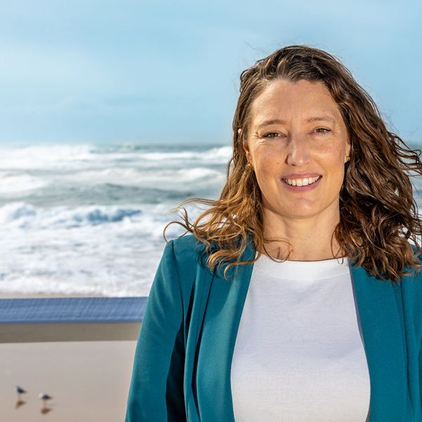 Dr Sascha Fuller standing in front of the ocean