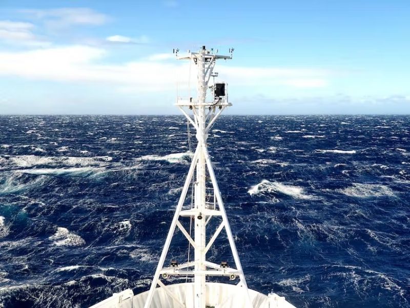 The front of a boat facing the rough seas of the open ocean. 