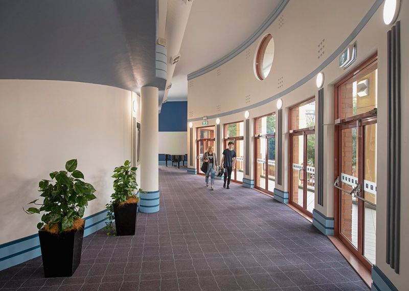 students walking through front foyer, along windows