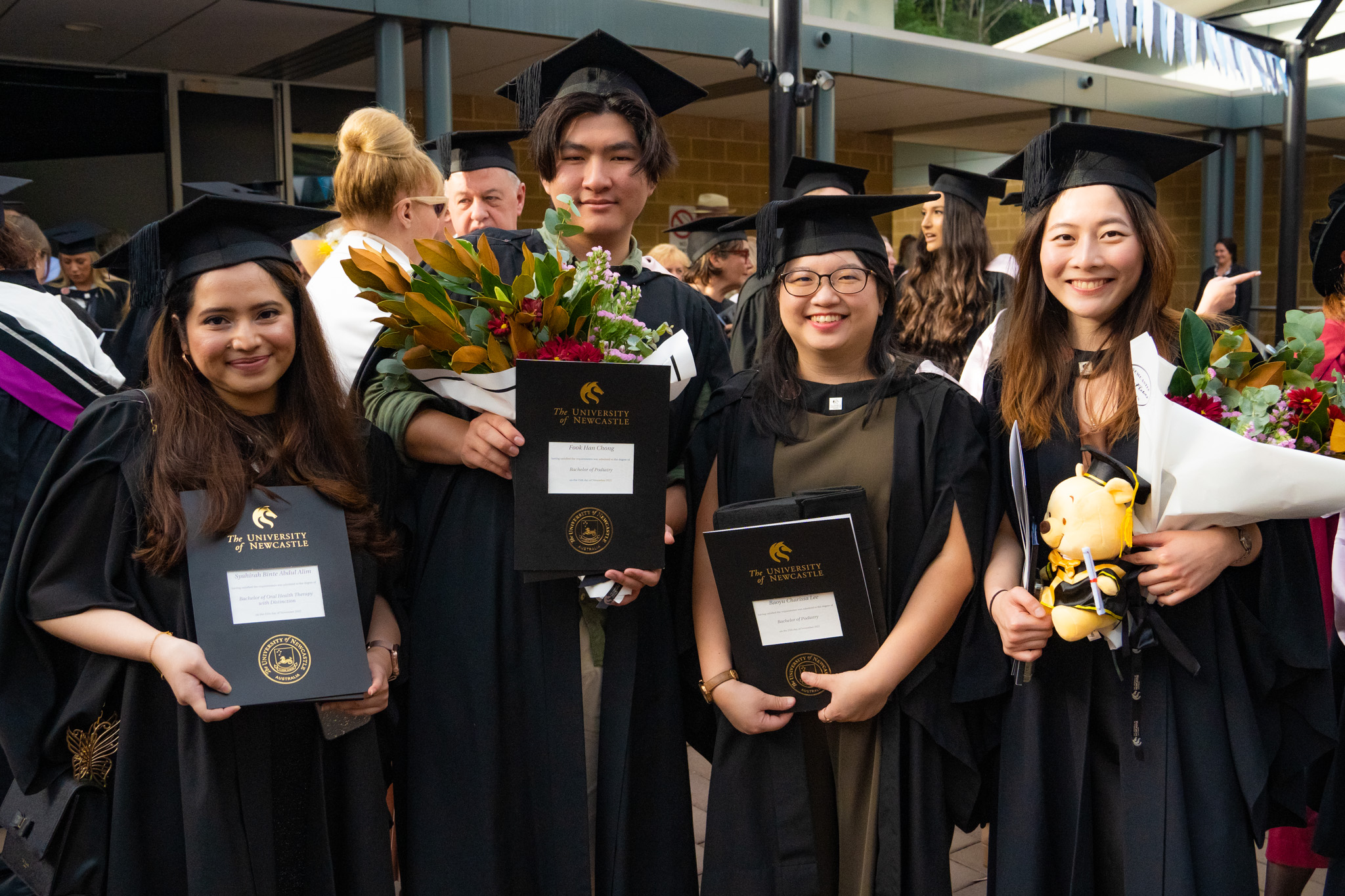 Syahirah Binte Abdul Alim (left) with fellow graduates from the College of Health, Medicine and Wellbeing