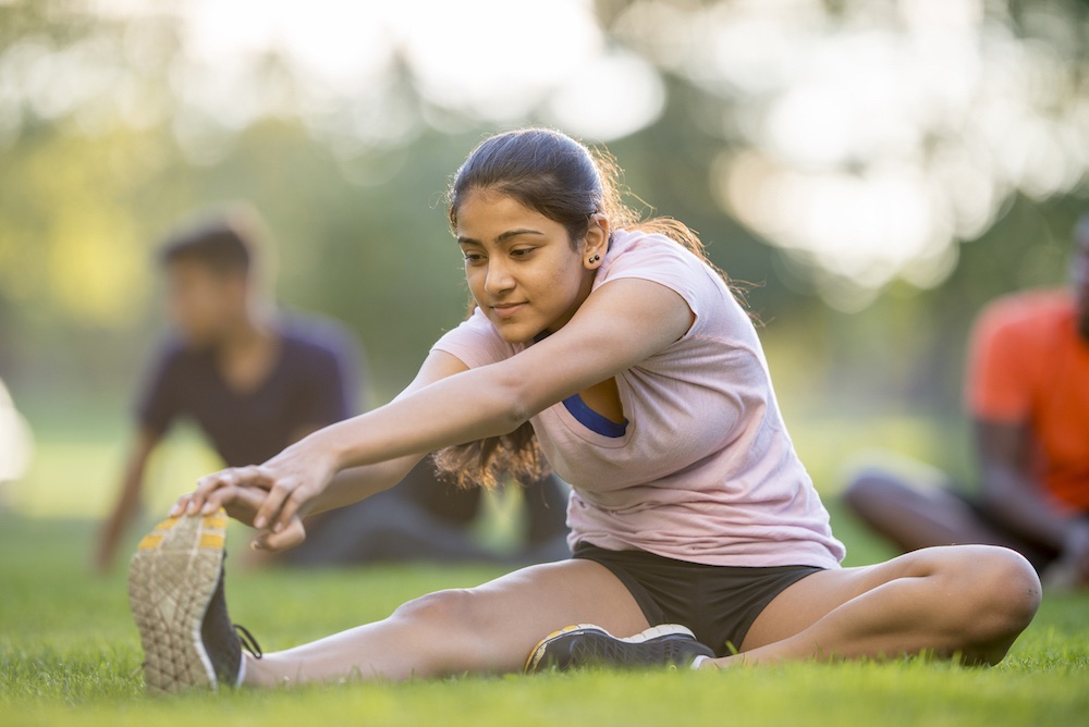 Photo of a girl stretching outdoors