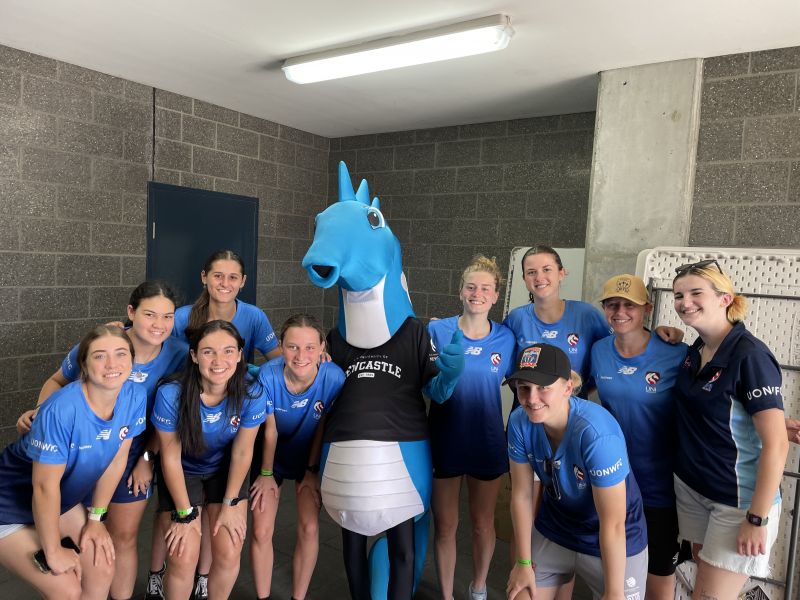 Group of players with the University of Newcastle Mascot