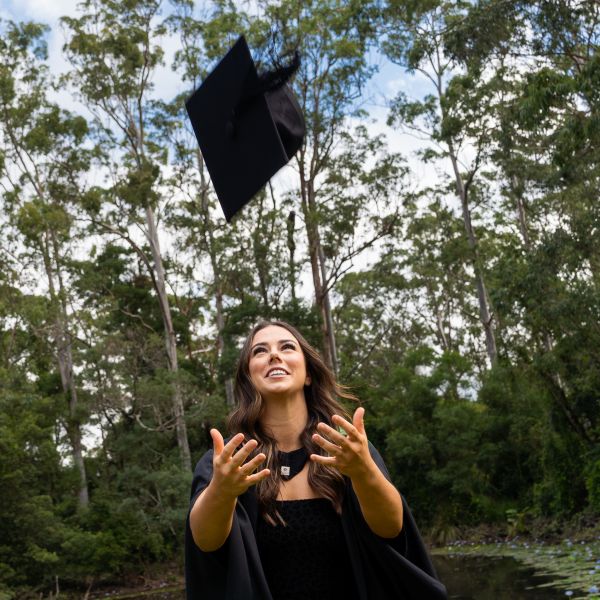 Graduate jumps to catch cap. Kicking goals on and off the field, Joeli proves you can do it all