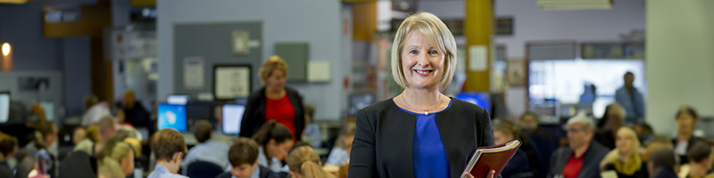 A woman standing in front of a classroom