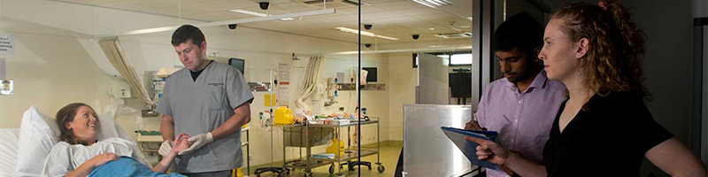 A health care workers tends to a patient in hospital