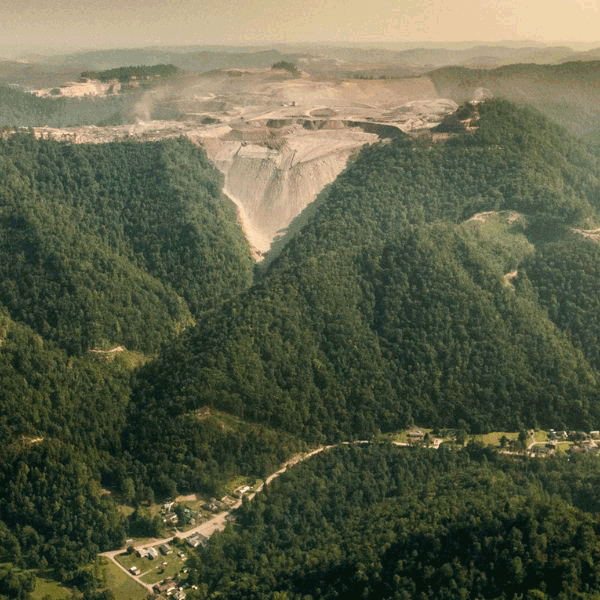 Mountaintop Removal Mountaintop forest area with mining tracks going up it