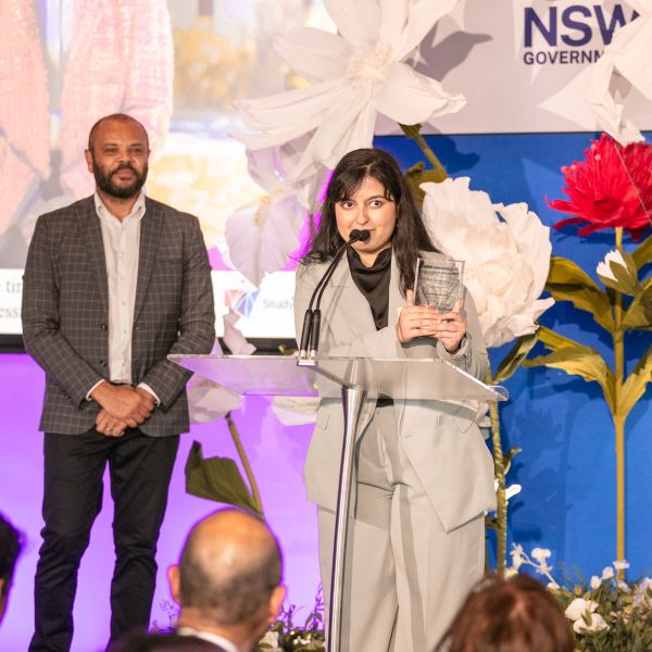Student accepts award on stage. University of Newcastle nursing students awarded at prestigious NSW International Education Awards.