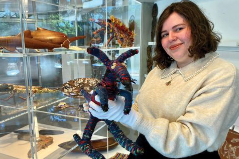 A female student holding a sculpture