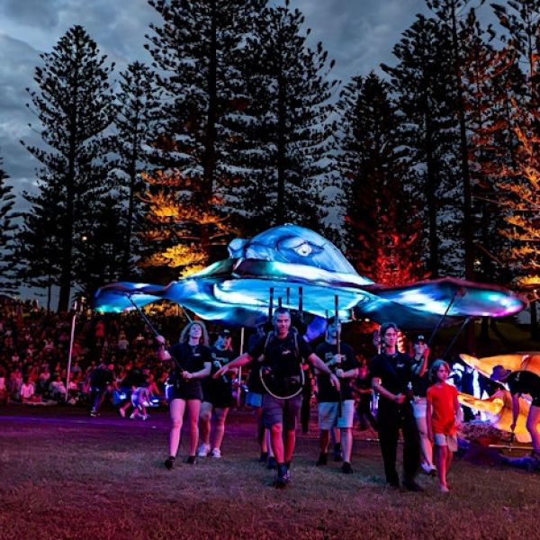 Photo of large whale puppet, illuminated in King Edward Park
