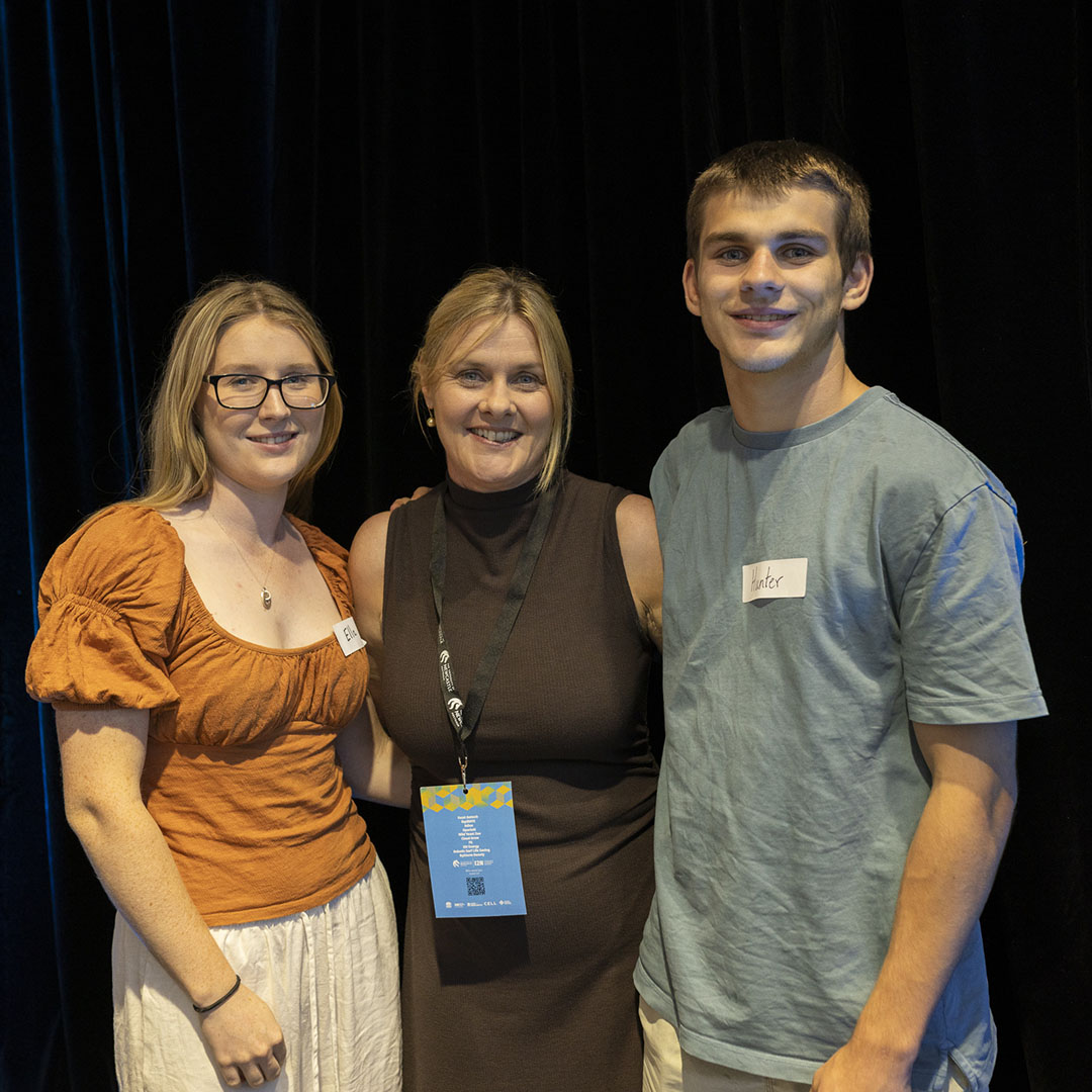 Three individuals standing side by side