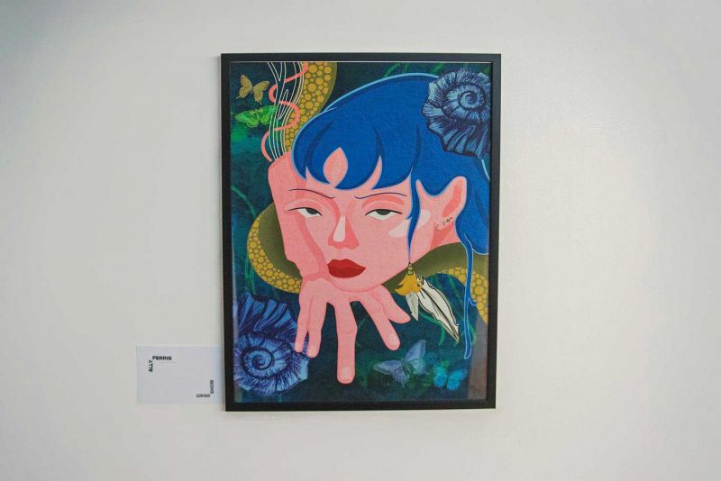 A framed artwork on a white wall