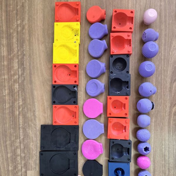 The original BYSTORM Beauty tool protypes arranged neatly on a wooden surface.