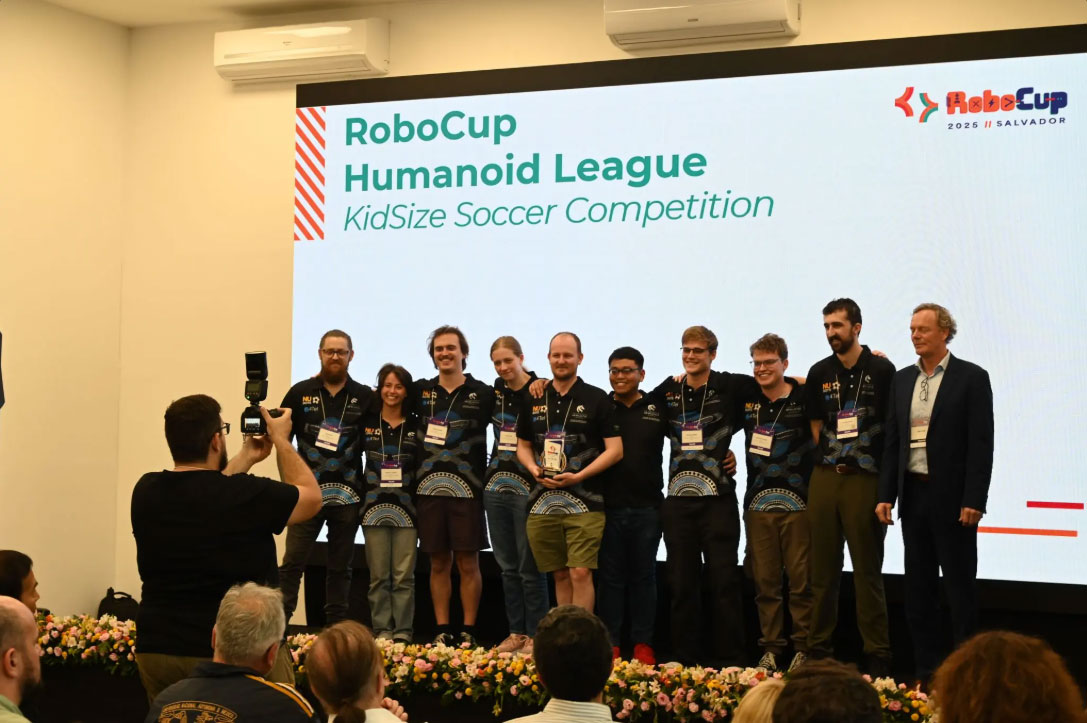 NUbots team pose for a photo with their awards