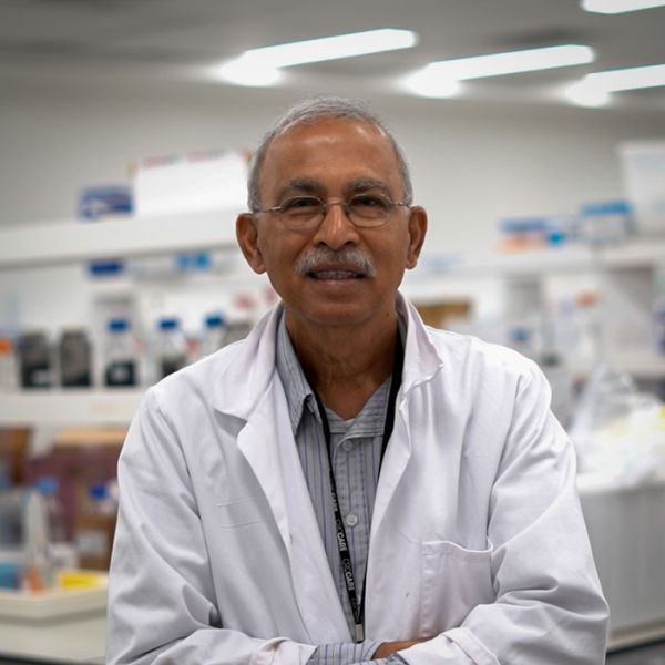 Laureate Professor Ravi Naidu in a lab smiling to camera