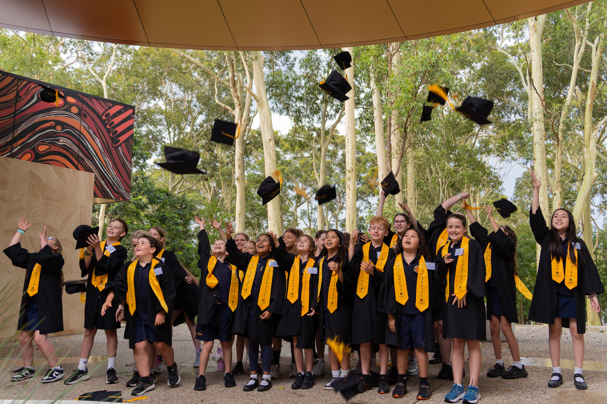 Childrens University Newcastle graduates from Elermore Vale Public School throw their hats to celebrate