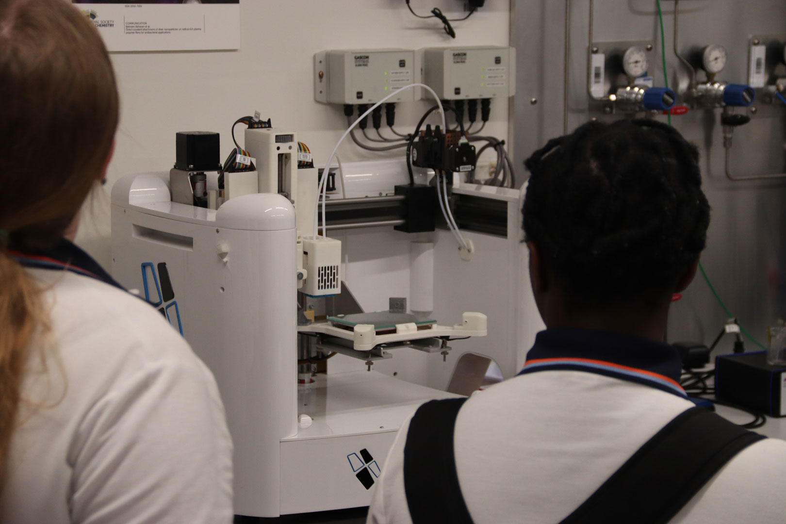 Students look at lab equipment