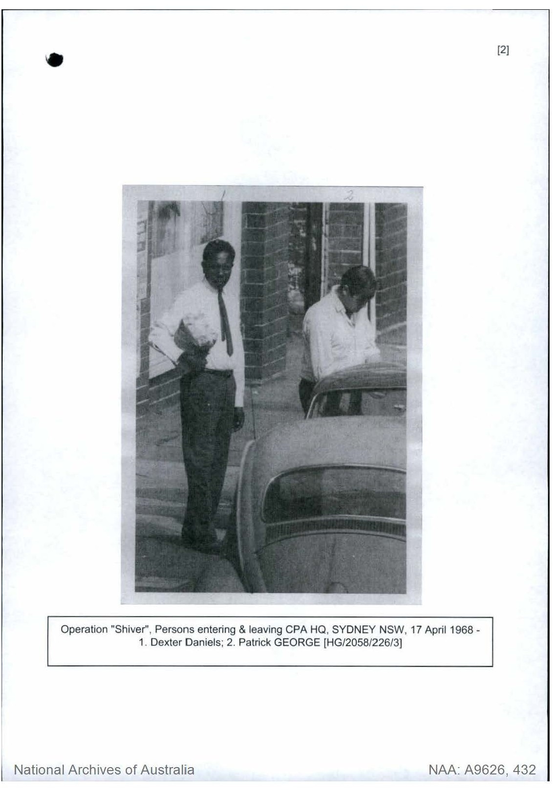 Photographs of Dexter Daniels taken by ASIO agents (Supplied: NAA) A black and white photograph two men standing in a street with car in foreground