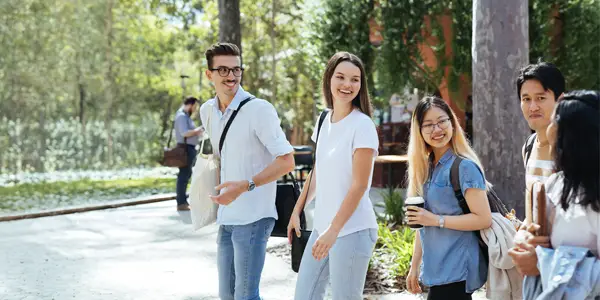 Five students walking through campus 600x300px