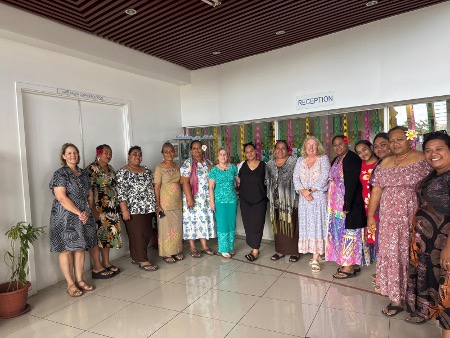 A group of women standing in a semi-circle smiling