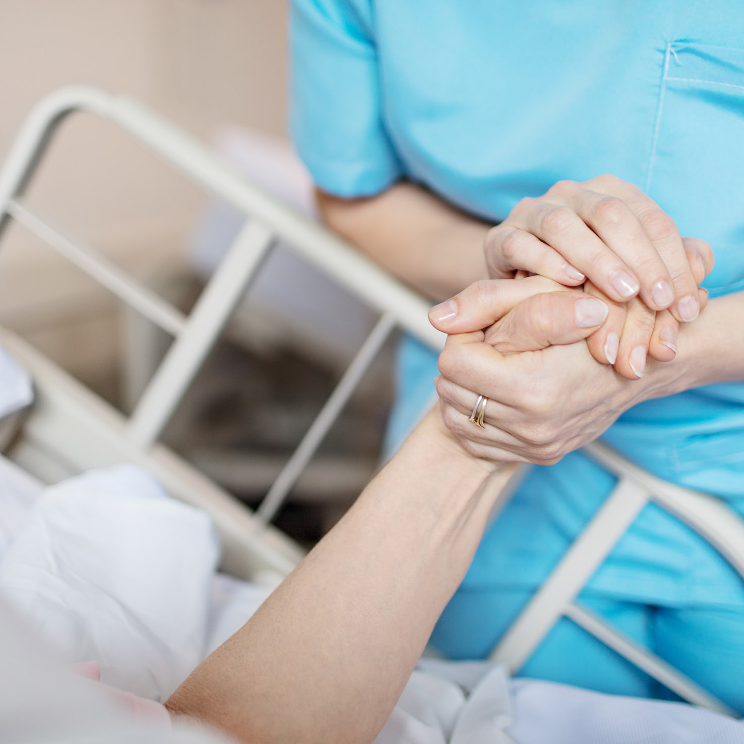 Nurse holding patient hand