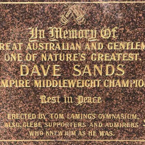 Brown marble plague with gold lettering saying 