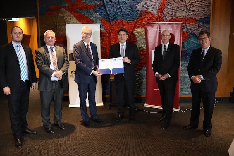 Signing at NSW Parliament House with the Hon Geoff Lee MP, Minister for Skills and Tertiary Education  Vice-Chancellors with Minister Lee