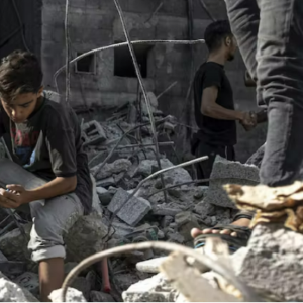 Image of a young boy sitting on on rubble . Amid Death and Destruction, the Latest Conflict in Gaza Highlights the Depth of its Humanitarian Crisis.