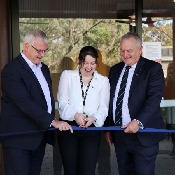 Professor Mark Hoffman, Jessica Philbrook and Alex Zelinsky cut the ribbon to open The House. University of Newcastle students welcomed to ‘The House’  