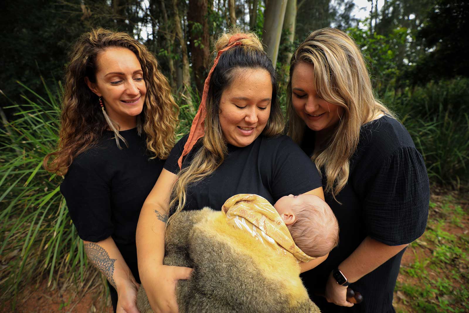 Dr Michelle Kennedy with a young aboriginal mother and baby