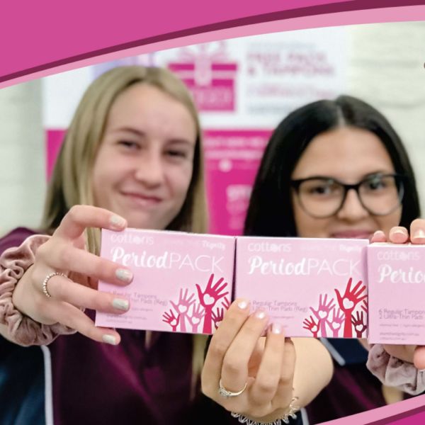 Young women holding up period packs. University Library offers free period products to those in need
