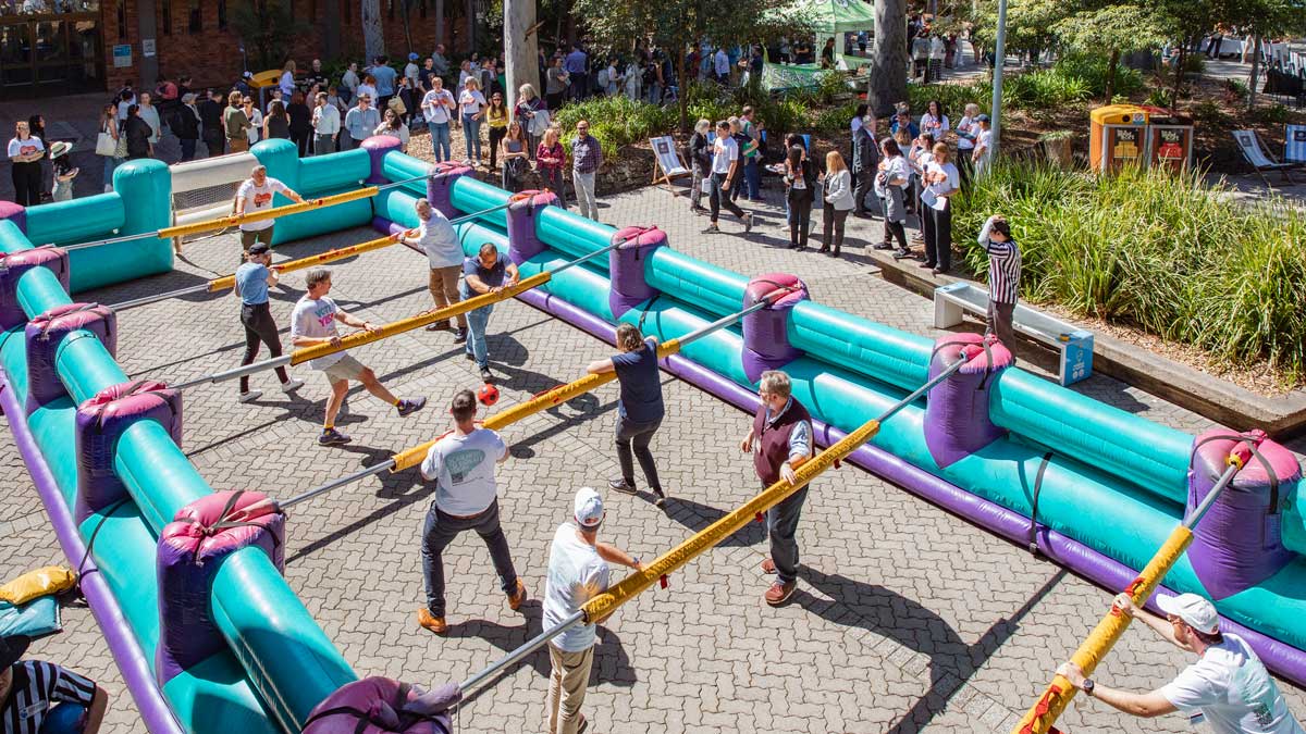 People inside a giant inflatable foosball court