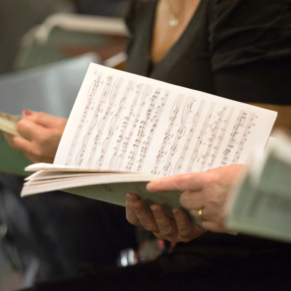 Person holding music sheets