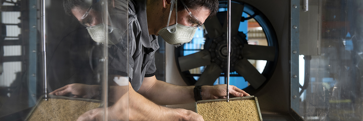 A scientist working with bulk solids
