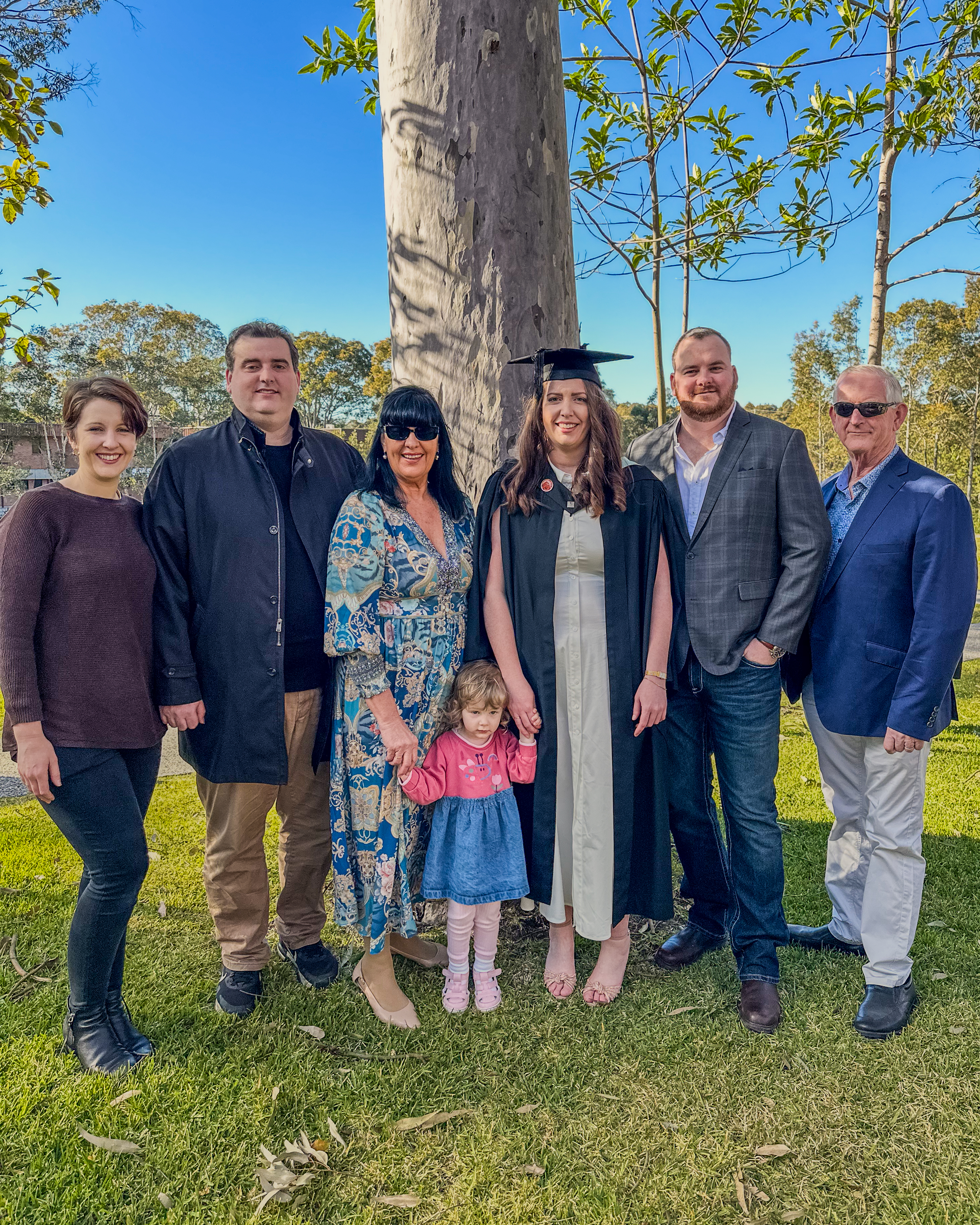 Rebecca Cramp in her graduation robes surrounded by her family