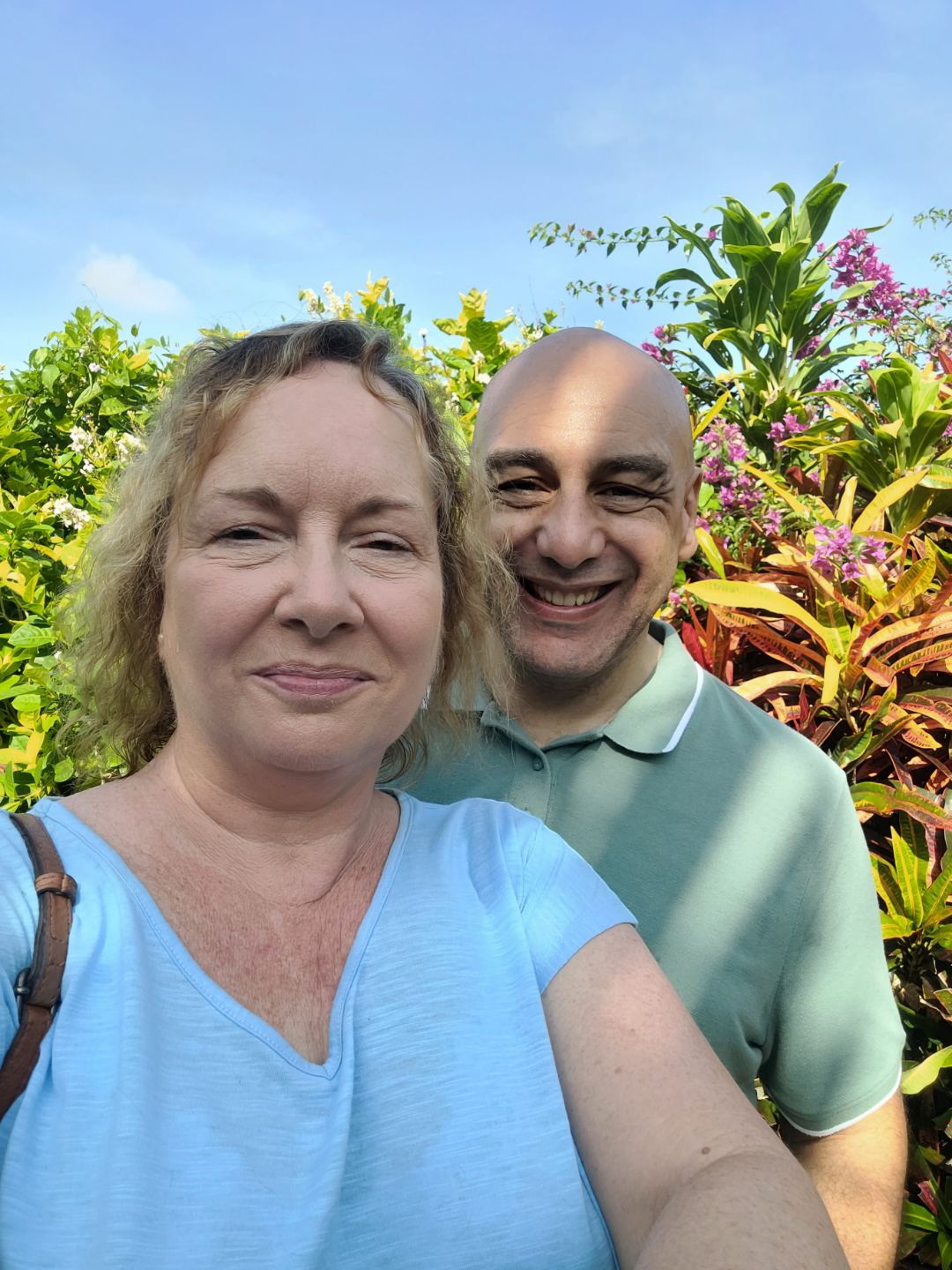Lisa Arthurton and her husband Neil Lisa and her husband Neil smile for a selfie with green plants and blue sky in the background