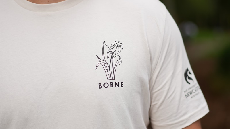 se-up photo of a t-shirt with flower design and university logo