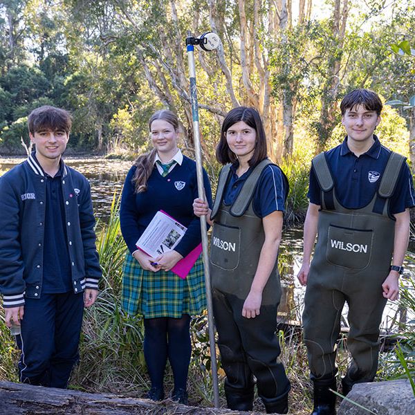 Students pose with equipment in front of a pond. Experiment Fest 2025 | Where Curiosity Meets Discovery