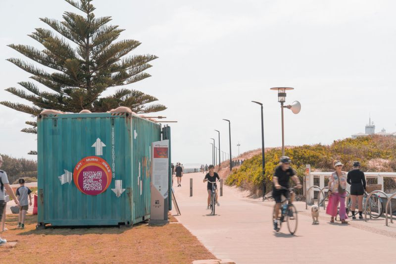 Shipping container sits next to a walkway