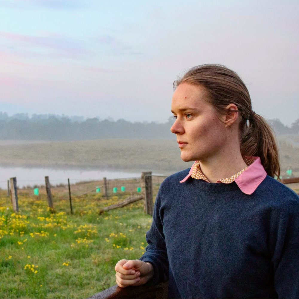 A woman looking out over a field.