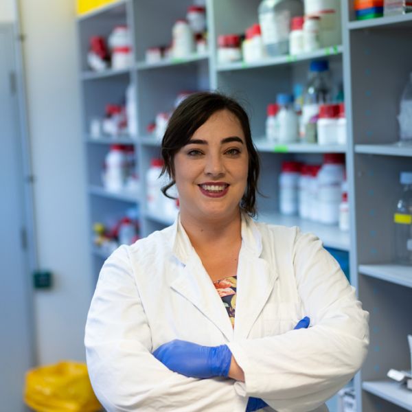 Dr Jacinta Martin smiling to camera in a lab