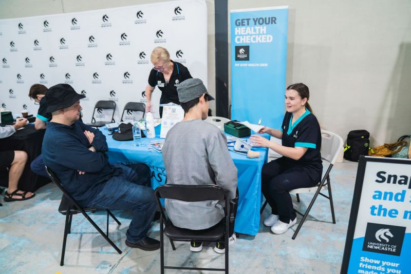 Nursing students doing free health checks with community members