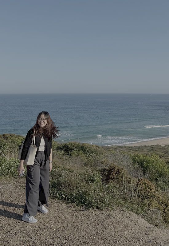 student-walking-beach